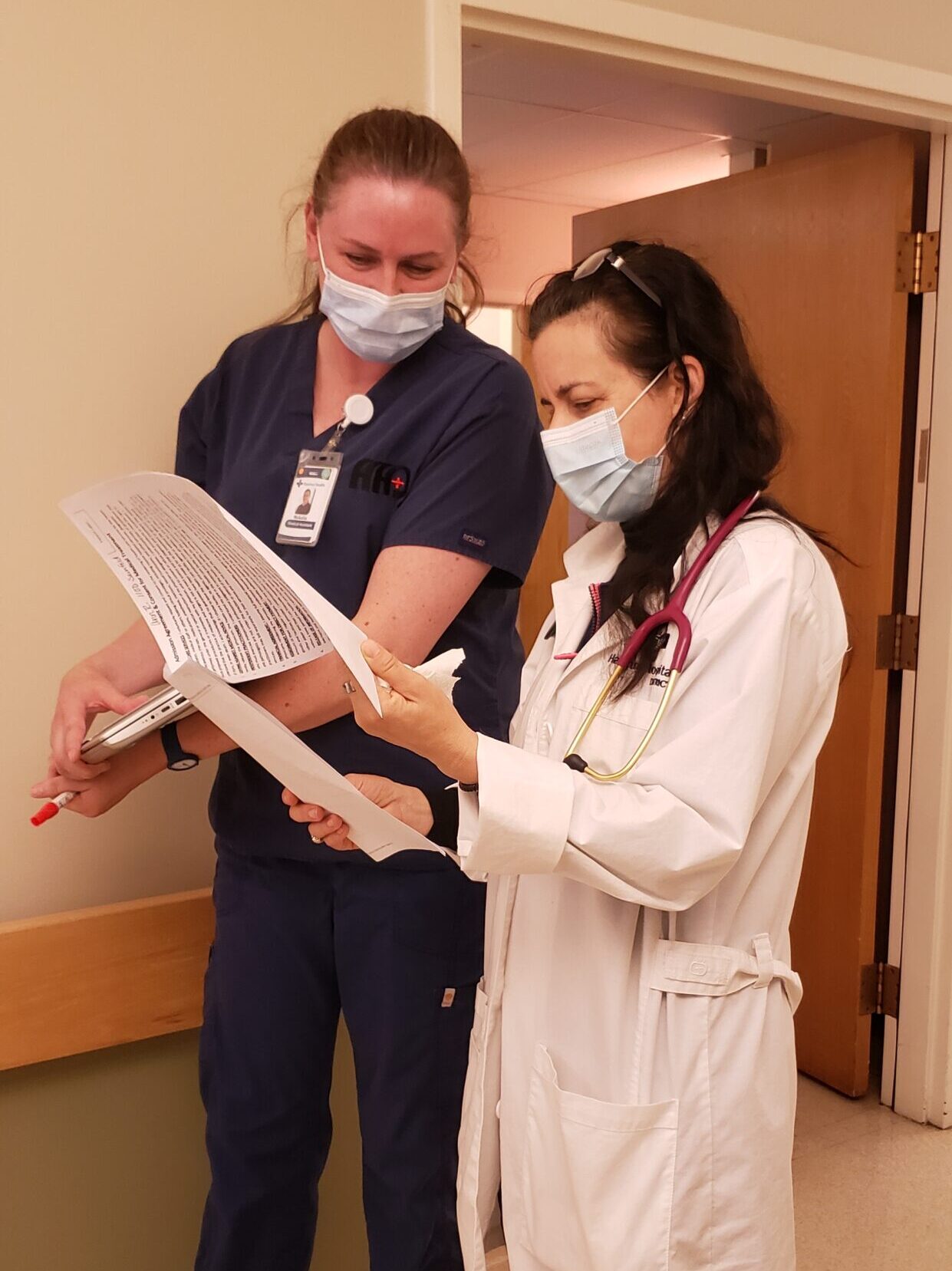 Dr. Seinfeld with Nurse reviewing charts