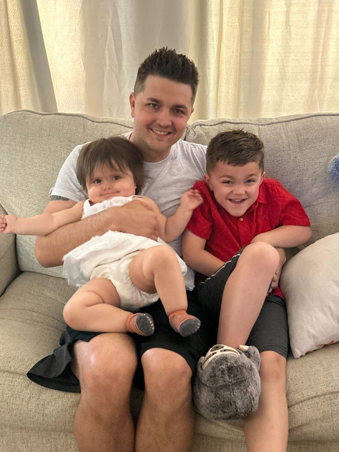 Dr. Hansen holding his son and daughter