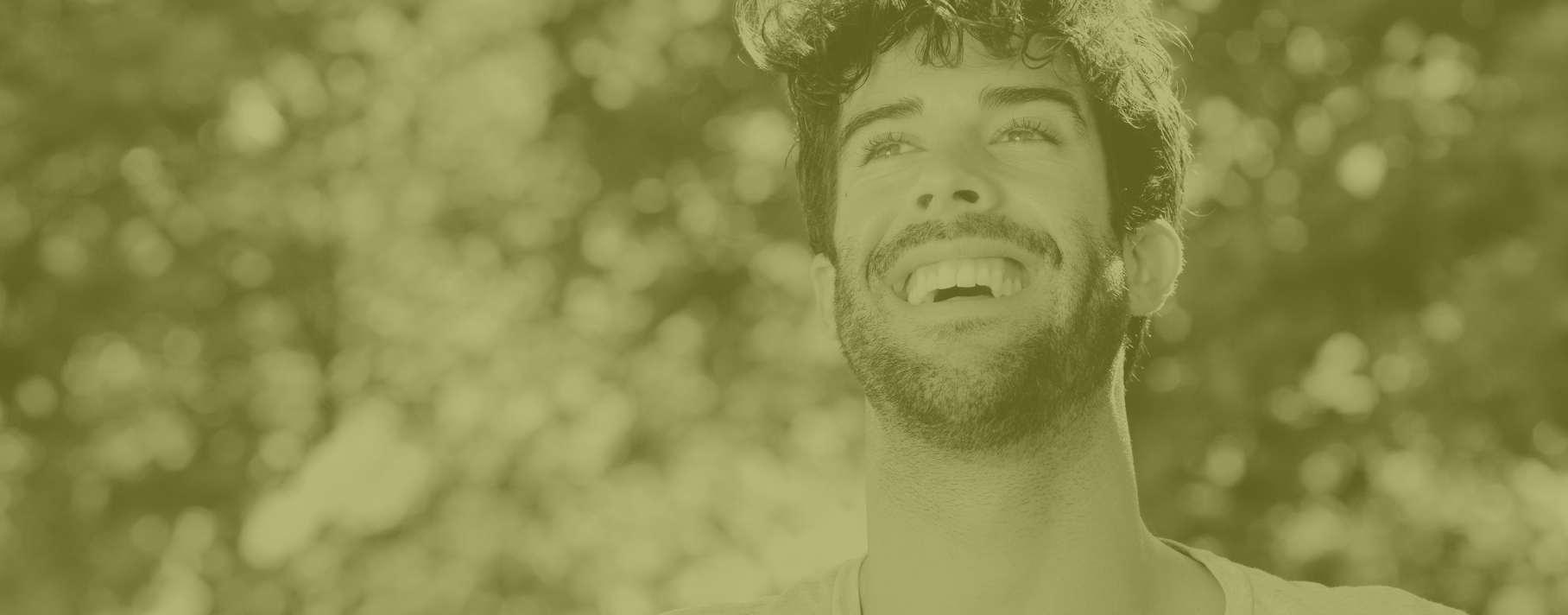 Man smiling under a tree